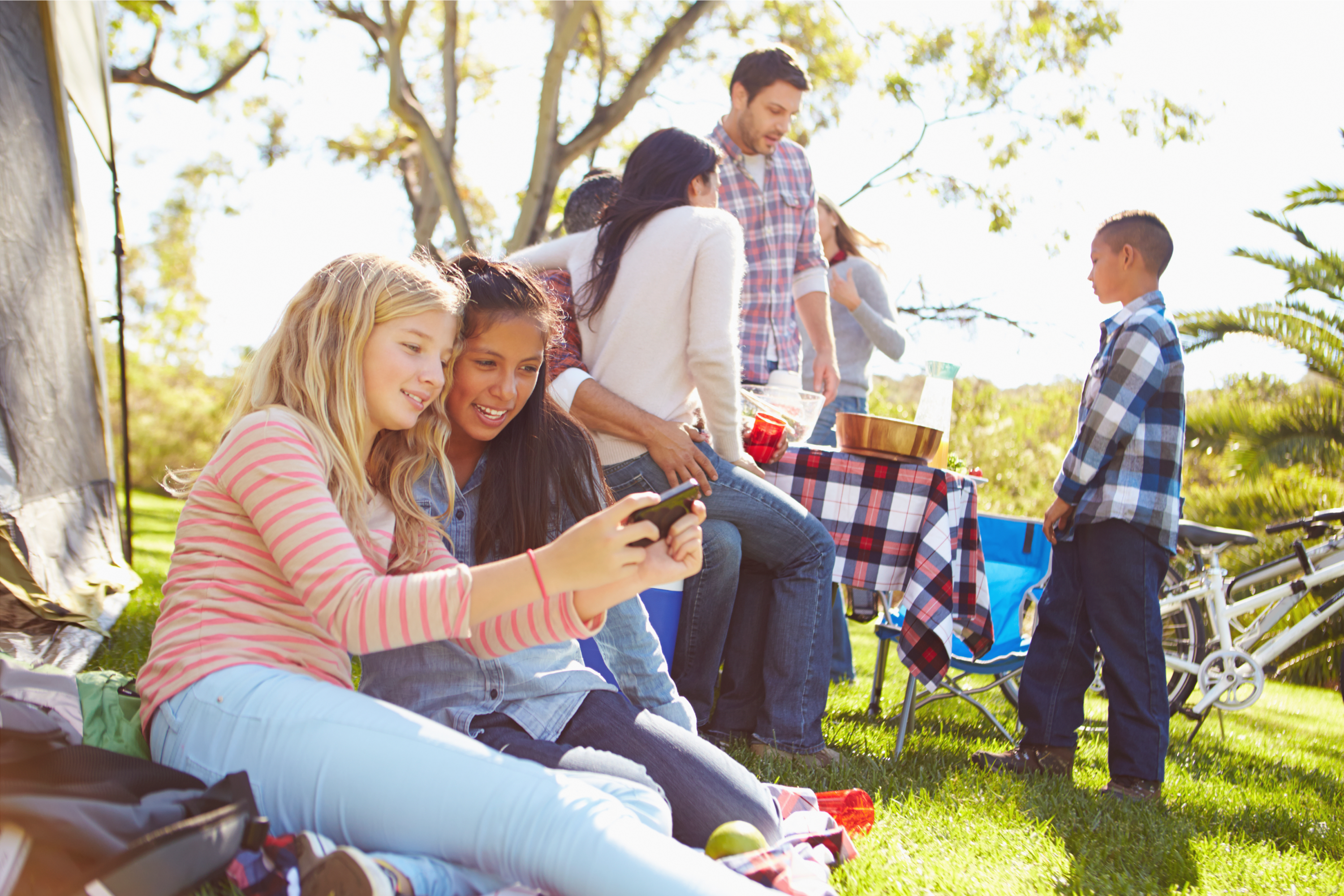 Family and kids watching Netflix outdoors